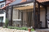 Premium 3x4 m waterproof roman blind installed on a dark wood pergola over a terrace with rope side accents.