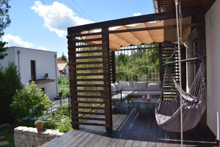 3x4 m waterproof premium roman blind canopy providing sun protection for a wooden garden terrace with lounge furniture