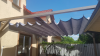 Retractable 3x4 m premium patio roman blind in grey for sun and water protection over a wooden terrace structure