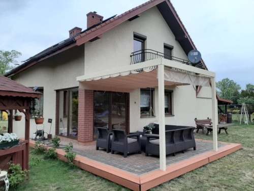 Cream 3x4 m retractable roman gazebo canopy over a modern outdoor patio set by a residential house house