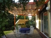 Premium 3x4m Roman terrace blind in cream, providing sun and waterproof protection over an outdoor patio area