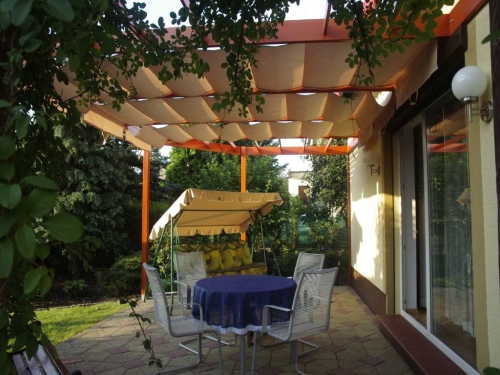 Premium 3x4m Roman terrace blind in cream, providing sun and waterproof protection over an outdoor patio area