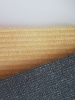 Close-up of beige and grey HDPE balcony screen swatches with breathable, UV-resistant mesh texture