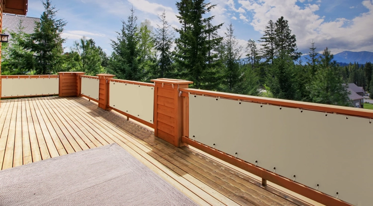 Custom breathable HDPE balcony privacy screen with UV resistance installed on a wooden deck railing overlooking a forest