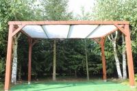 Custom size white retractable sun shade sail installed on a wooden garden pergola in a backyard setting.