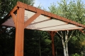 Custom HDPE sun shade sail mounted on a wooden pergola for outdoor UV protection and shade.