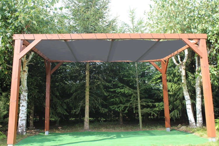 Gray HDPE sun shade sail mounted horizontally on a wooden pergola structure in a green garden setting.