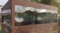 Custom-made transparent PVC deck tarp gazebo enclosure with brown borders and metal eyelets outdoors.