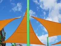 Custom triangular waterproof orange garden shade sail attached to a green metal pole against a blue sky.