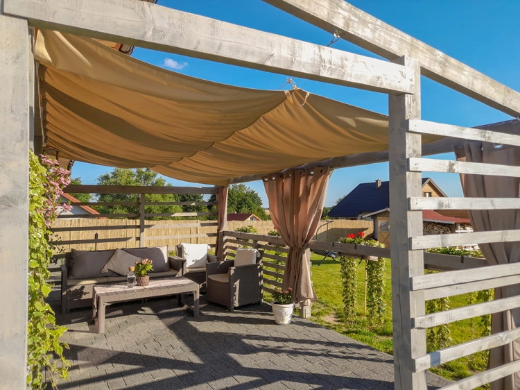 Retractable waterproof 3x5 m sun shade sail over a modern garden patio with outdoor lounge furniture