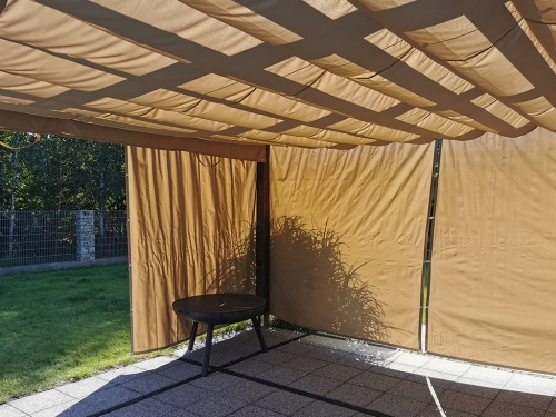 Terrace Roman blind on a 3x4 m pergola with waterproof tan fabric used for sun protection over a stone patio