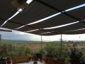 Toldo para pérgola Premium gris impermeable que protege la terraza con vistas al paisaje y la naturaleza