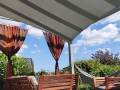 Premium wasserdichtes Sonnensegel rechteckig 3x4 m über einer Terrasse mit Gartenmöbeln und Hängematte