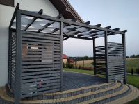 Woven white sunshade fabric panels installed on a dark wood pergola over a paved patio terrace.