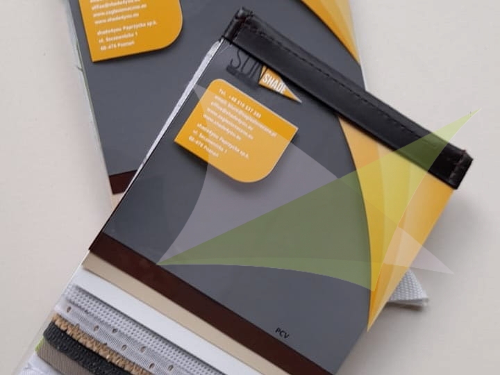 Professional material sample book from Sun Shade showing various colorful fabric and PCV swatches for sun shades