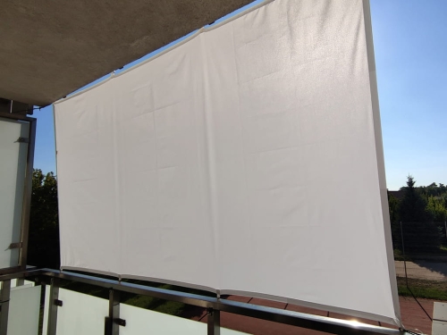 White waterproof balcony sun shade sail mounted on a railing and ceiling for privacy and protection
