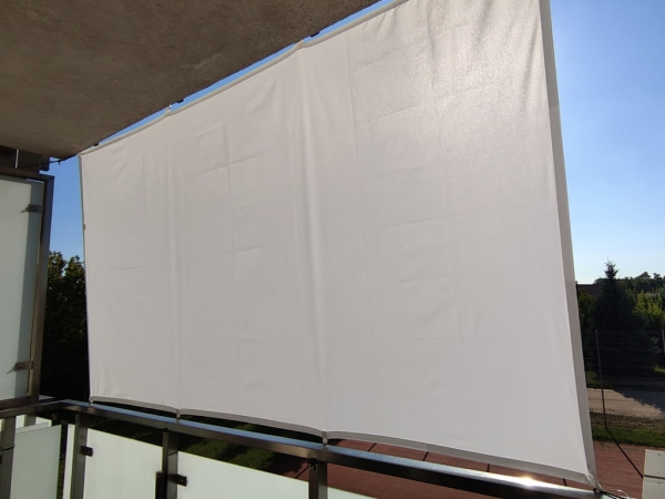 White waterproof balcony sun shade sail mounted on a railing and ceiling for privacy and protection