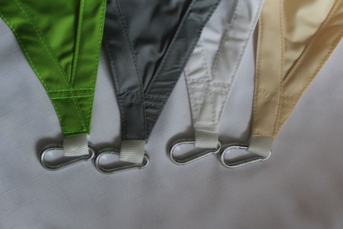 Waterproof balcony sun shade sails in green, grey, white, and beige with metal carabiner hooks.