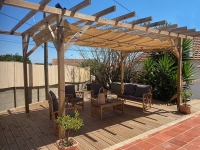 Square 3x3m beige Roman blind canopy installed on a wooden pergola over a deck with outdoor lounge furniture