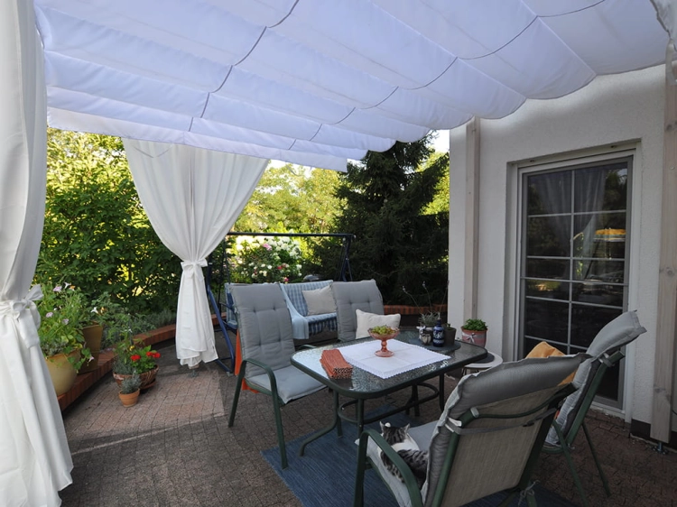Premium waterproof pull-down roman canopy shade over a patio dining area on a terrace