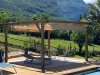 Retractable waterproof roman blind for a 3x4 m wooden pergola on a sunny deck overlooking mountains