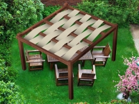 Outdoor waterproof fabric strips woven onto a wooden garden pergola over a wooden dining set on a green lawn