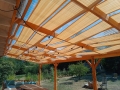 Sandfarbenes HDPE-Sonnensegel für Pavillons, montiert an einer Terrassenüberdachung aus Holz