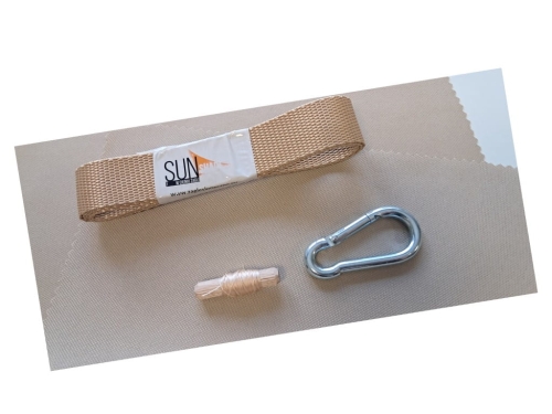Repair kit with a tan nylon strap, metal carabiner, and wooden peg on beige fabric.