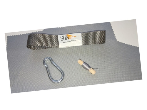 Sun Shade repair kit with grey webbing strap, metal carabiner, and spool of thread on a grey fabric background