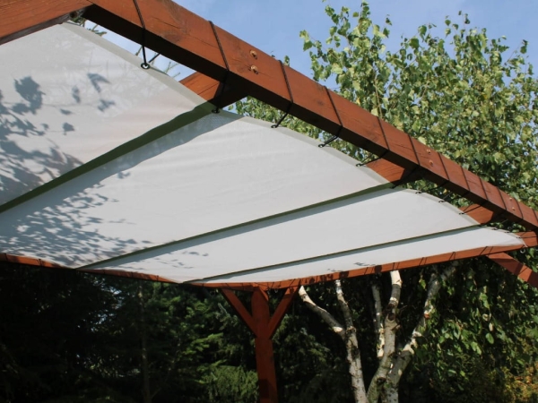 Custom size white wave shade sail on a wooden pergola providing garden sun protection.