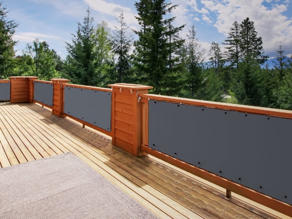 Customized grey HDPE balcony privacy screen installed on a wooden deck railing for UV protection and breathability