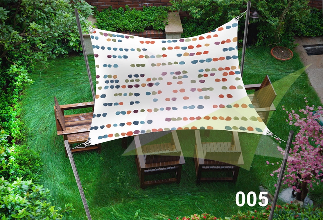 Custom-sized decorative patterned sun sail shade over wooden garden chairs on a green lawn.