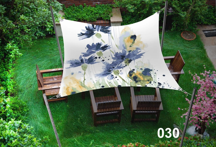 3x3 m waterproof garden shade sail with a floral print over a wooden seating area in a lush green backyard.