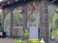 Custom transparent terrace tarp with printed stone-patterned frame and arched windows enclosing a hot tub area
