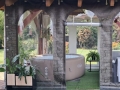 Telone trasparente per terrazza con stampa effetto muro che copre una vasca idromassaggio gonfiabile rotonda sotto una tettoia