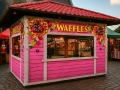 Rosa Holz-Waffelstand mit buntem Fruchtaufdruck auf einem Weihnachtsmarkt