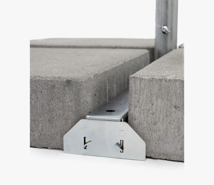 Metal cross base for an advertising parasol weighted with concrete paving slabs for stability at outdoor events