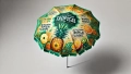 Tropical parasol beach umbrella featuring fruit graphics like pineapple and mango with tropical flavors text.