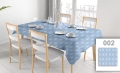 Custom blue tablecloth with white leaf pattern on a set dining table with chairs in a bright room