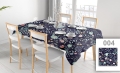 Custom printed floral tablecloth on a dining table set for four with white chairs and place settings.