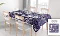 Custom printed floral tablecloth in navy blue and white on a dining table with chairs and plates