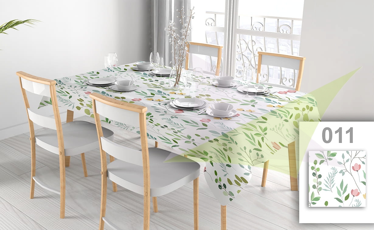 Custom printed tablecloth with a floral pattern featuring colorful leaves and flowers on a white dining table set.