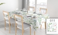 Custom printed tablecloth with a floral pattern featuring colorful leaves and flowers on a white dining table set.