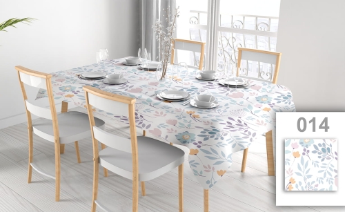 Floral pattern stain-resistant tablecloth on a dining table with chairs and place settings in a bright room