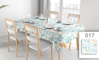 Custom stainproof floral tablecloth with orange and teal flowers on a dining table with chairs and place settings.
