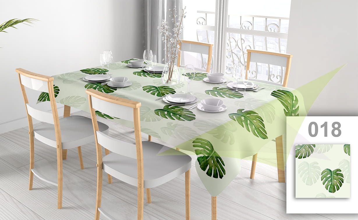 Customizable stain-resistant tablecloth with watercolor monstera leaf print on a set dining table with chairs