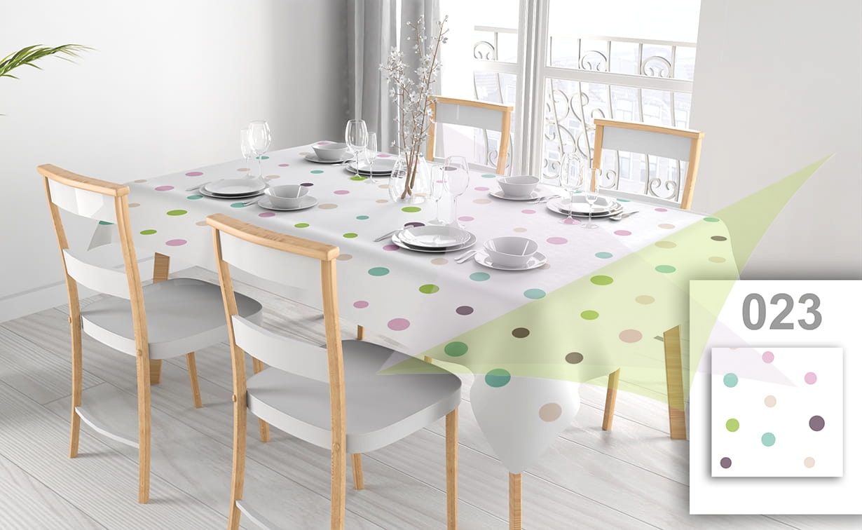 Custom stain-resistant tablecloth with colorful polka dot print on a dining table with chairs and place settings