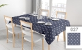 Custom-made navy blue tablecloth with a white anchor pattern on a set dining table with chairs and wooden floor