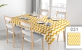 Custom waterproof tablecloth with yellow and white chevron pattern on a set dining table with chairs.