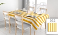 Custom striped tablecloth on a set dining table with white chairs in a bright room